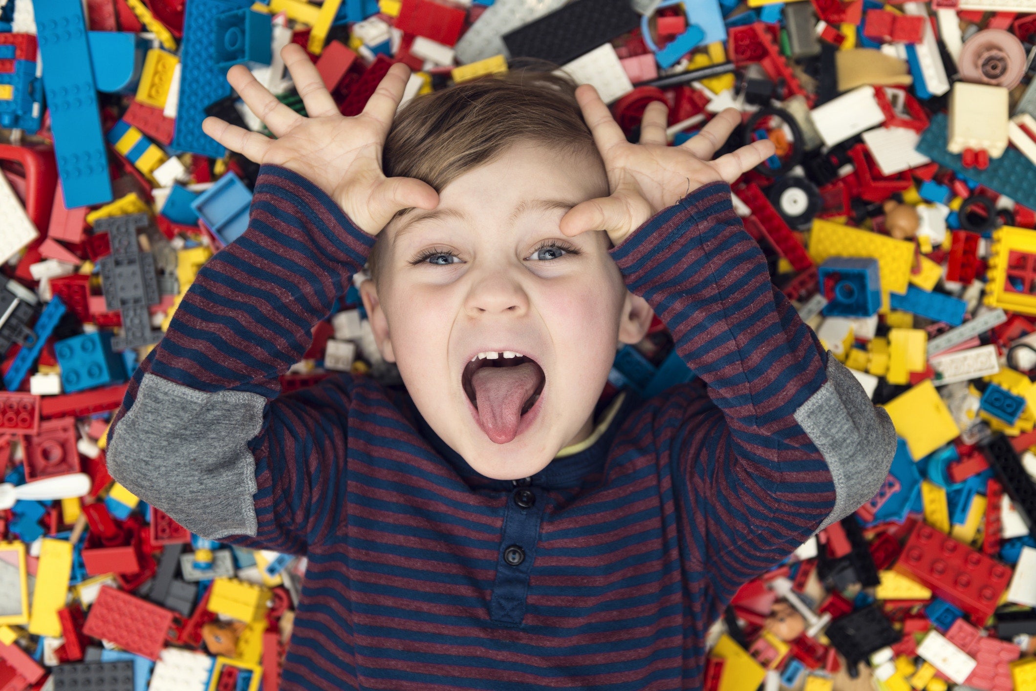 Playful boy between plastic blocks