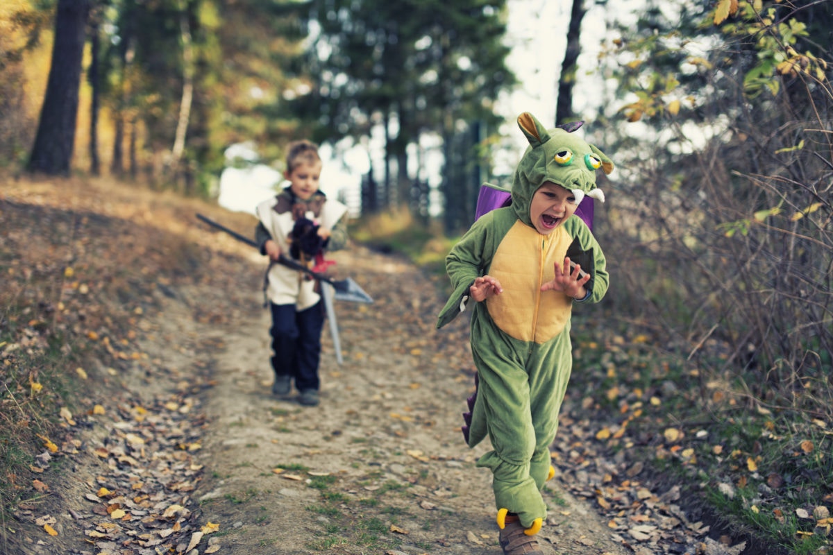 young happy girl wearing dragon costume