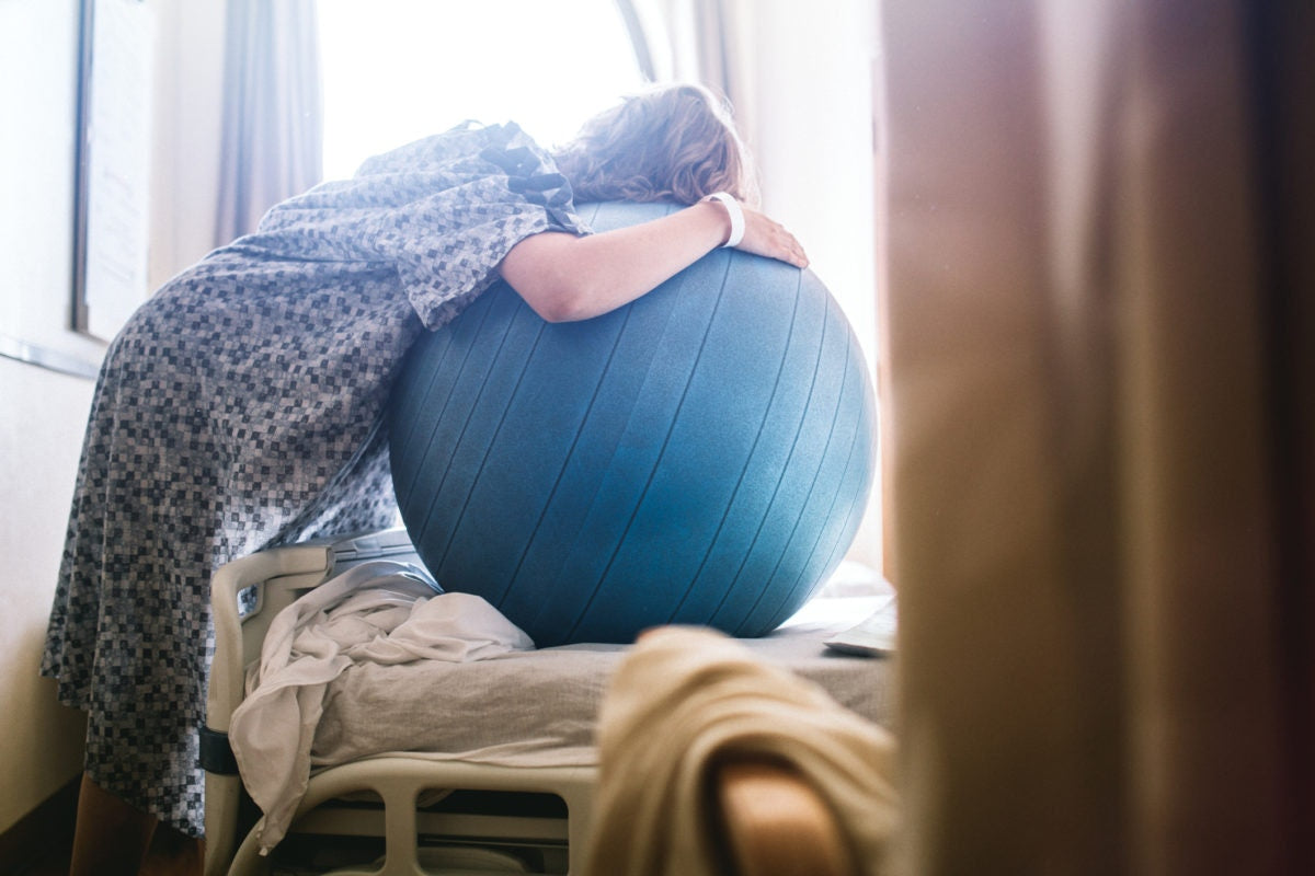 woman using a birthing ball in hospital