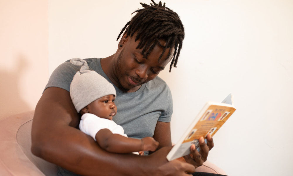 dad reading to baby son
