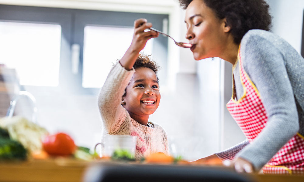 son cooking with his mother