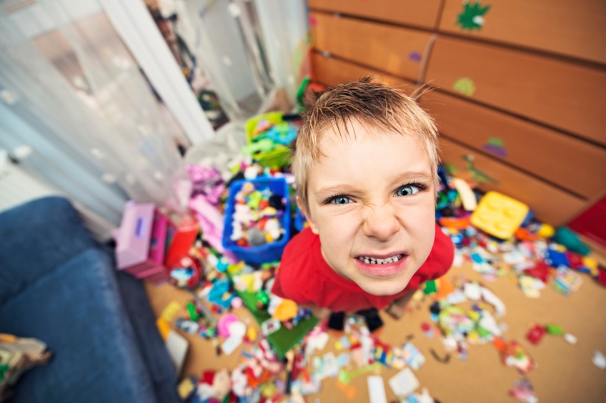 aggresive boy in a messy room