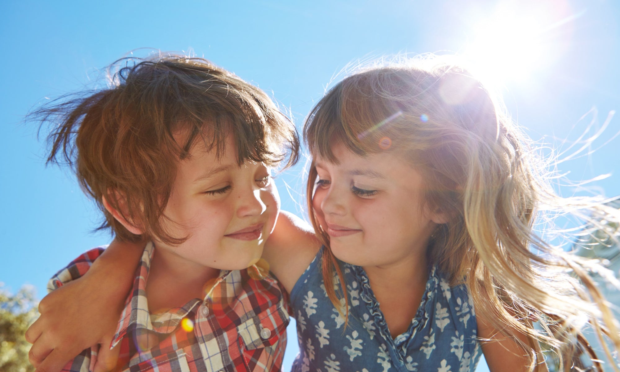 Two child friends holding each other