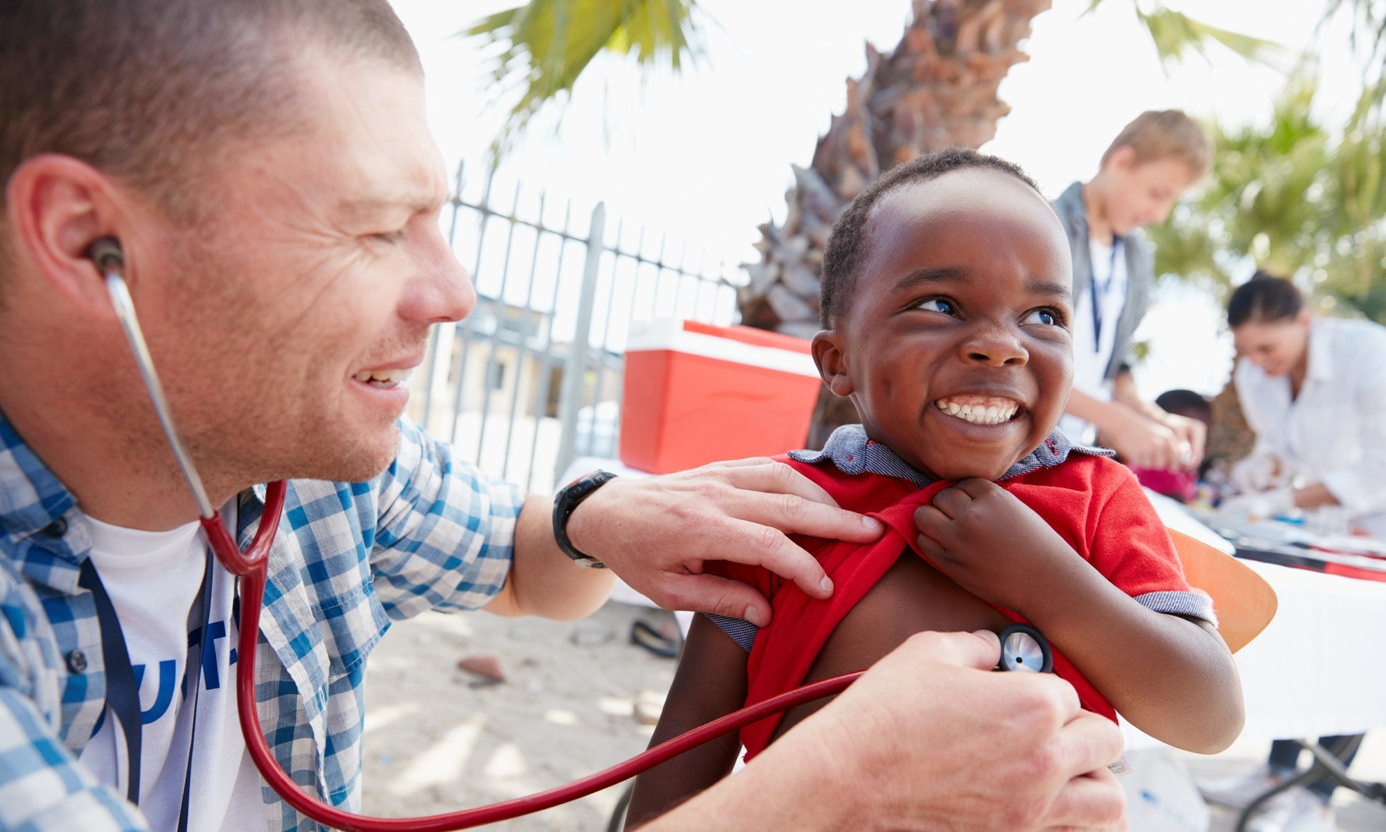 doctor checking little boy heartbeat