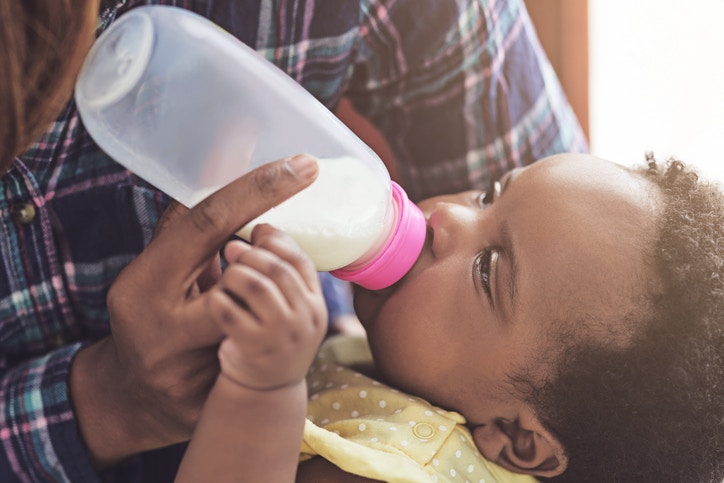 young lady feeding her child