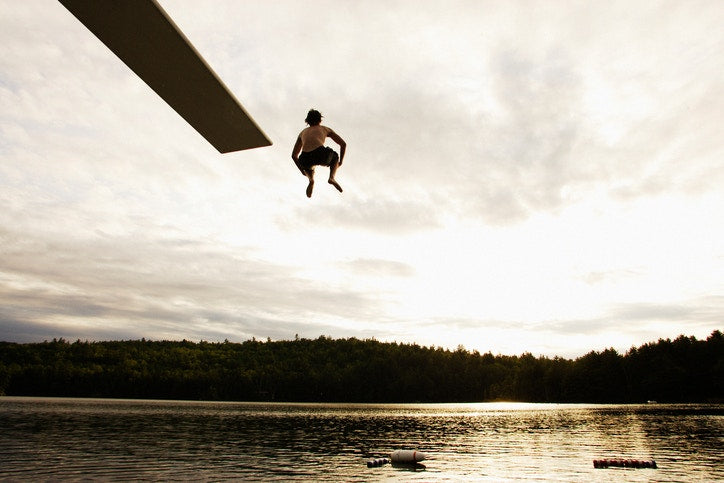 young man jumped into the water from a height 