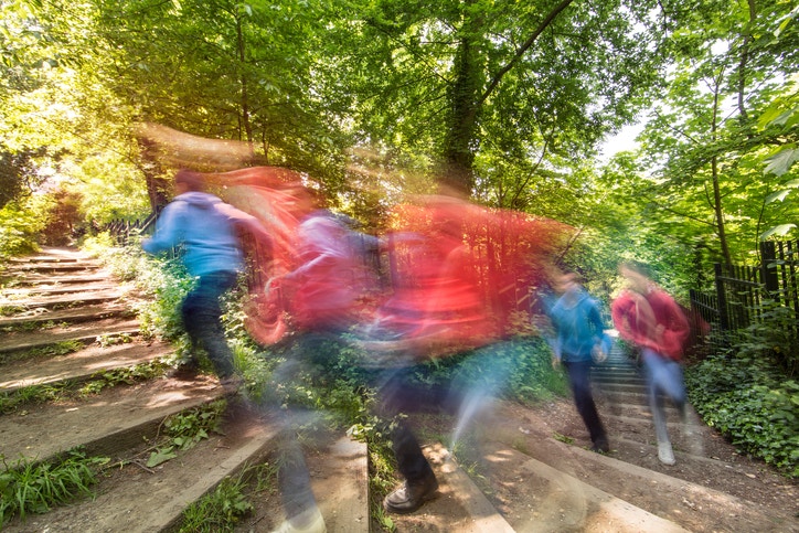 blur image of people walking up staris