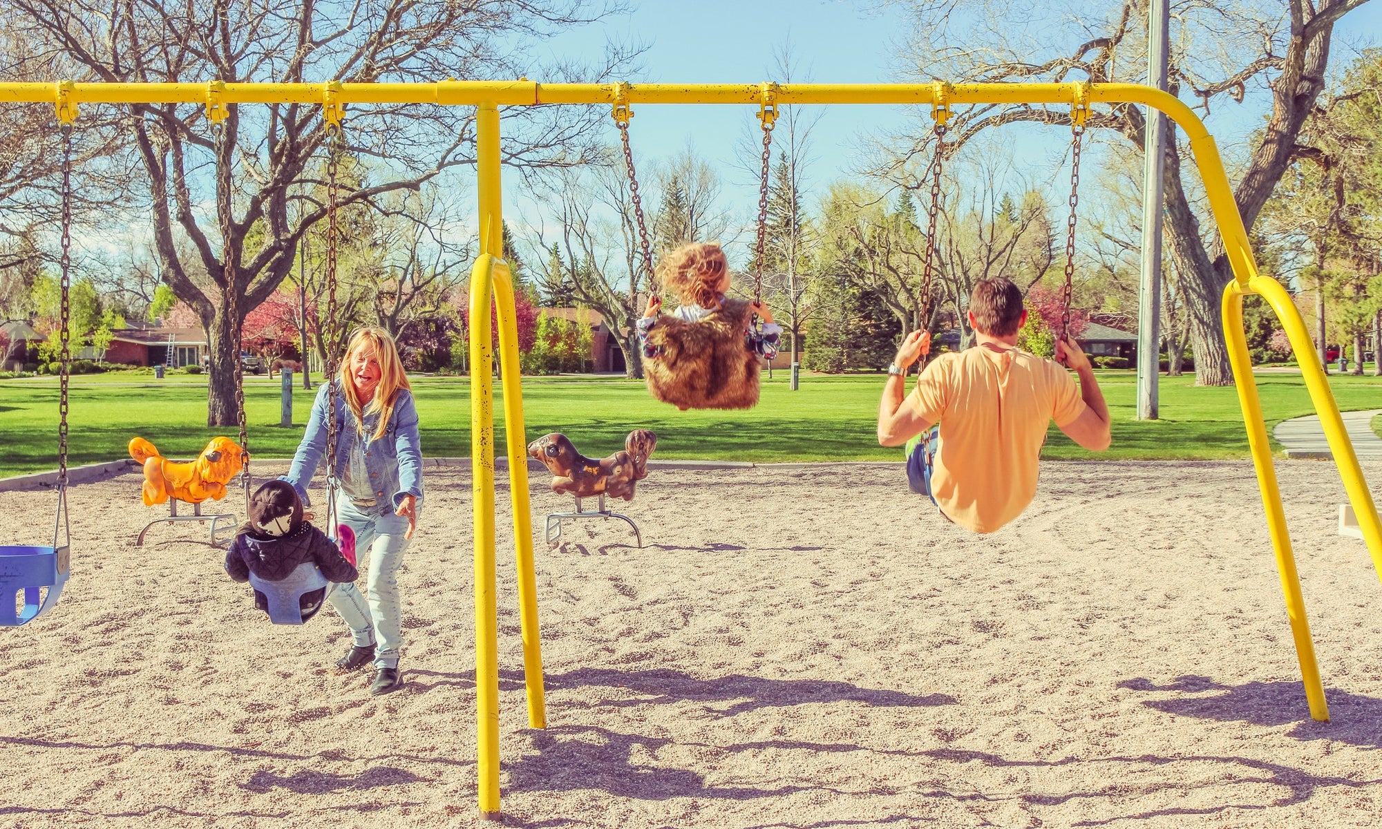 Happy family having fun together on playground