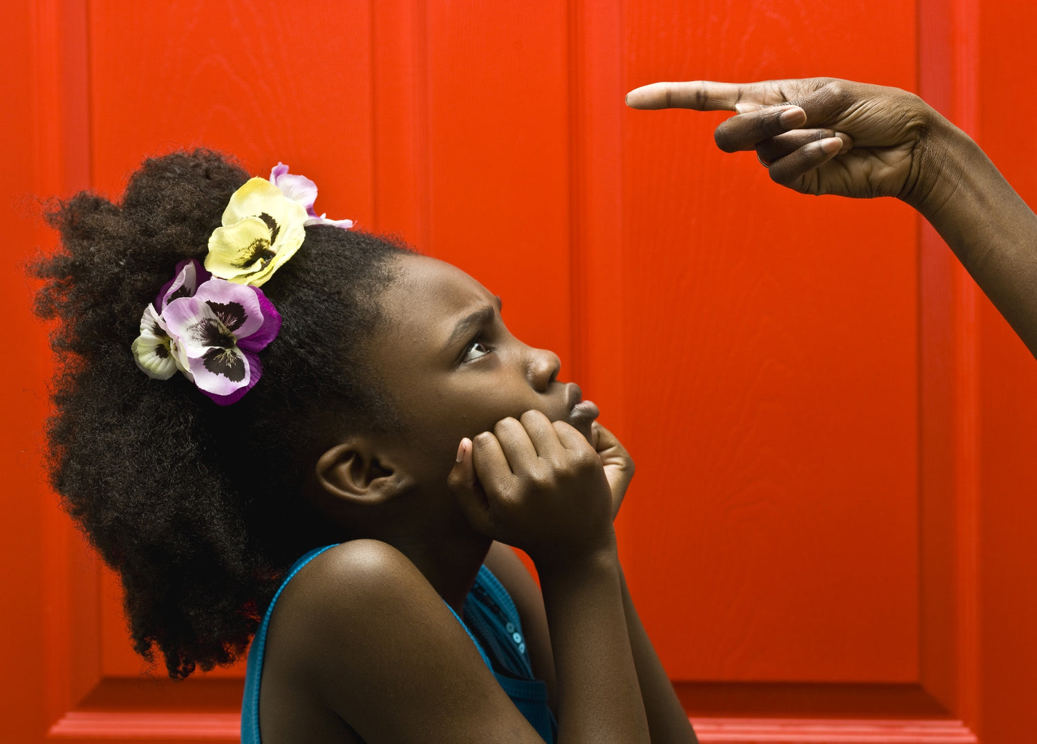 sad young girl looking at her mother's finger