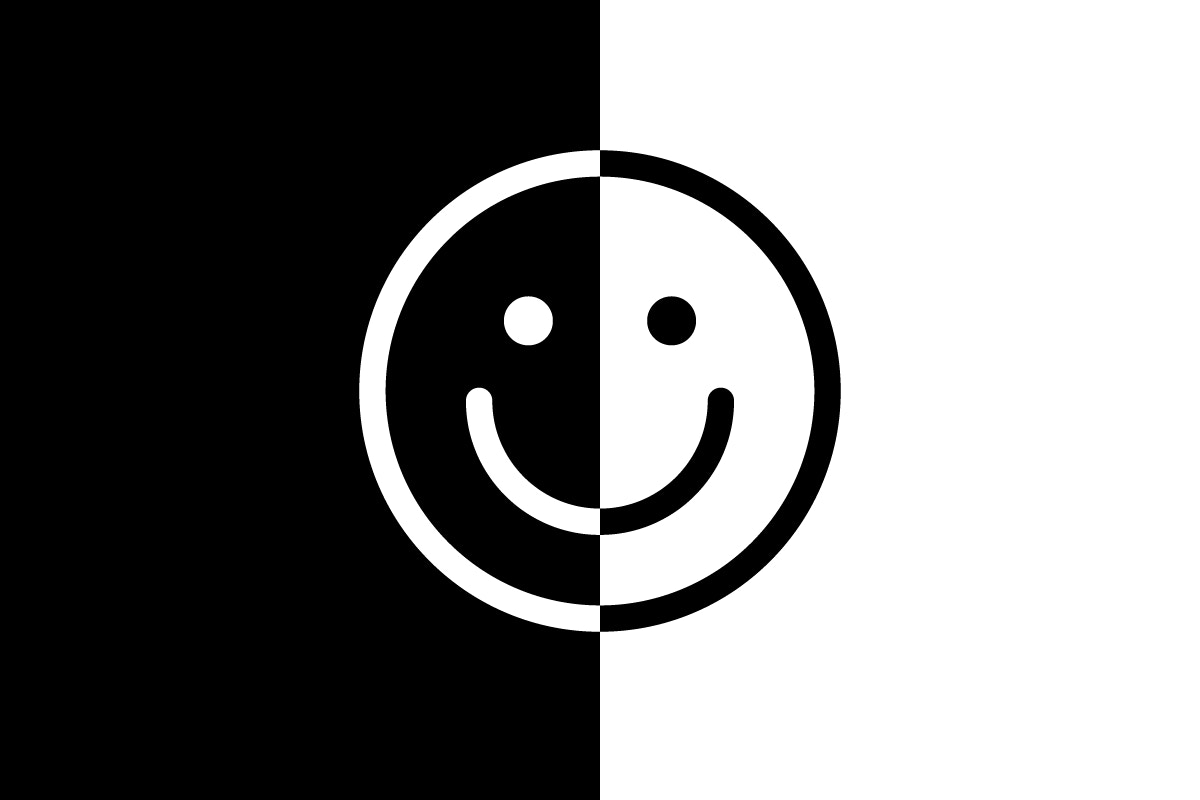 happy face emoji in half black and half white