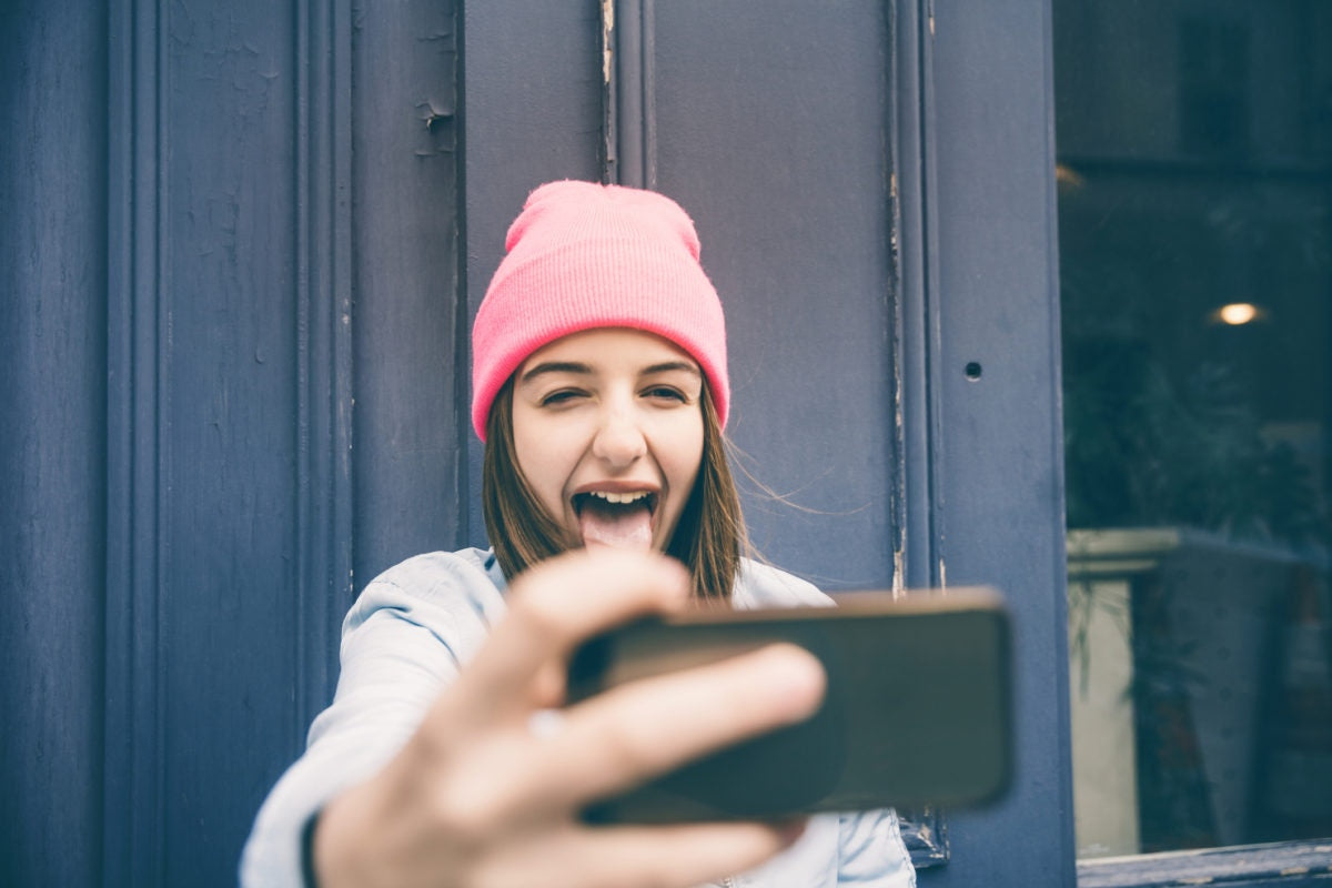 A girl is taking funny selfie