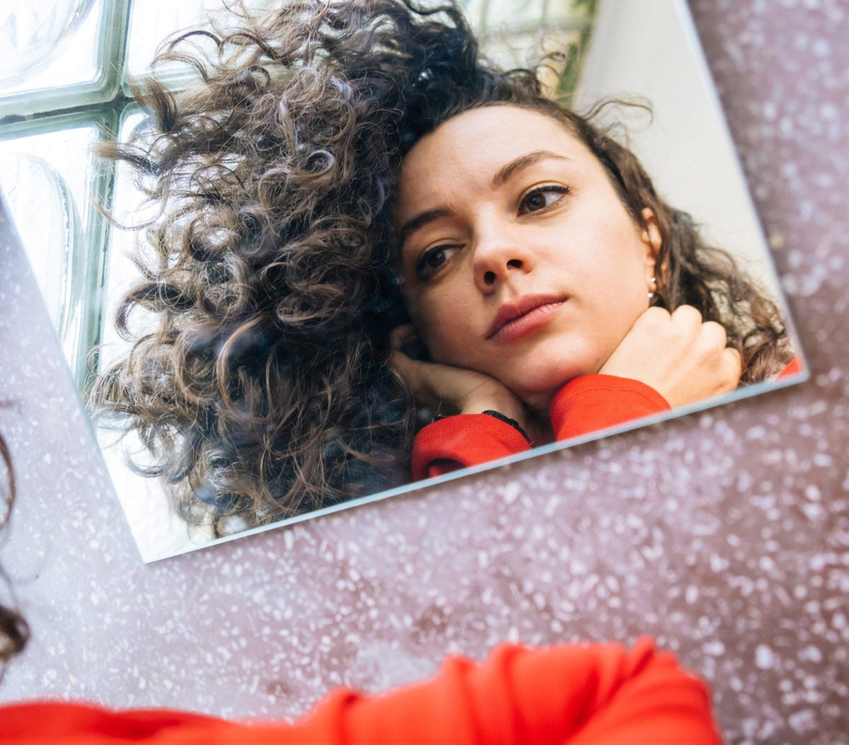 A girl is watching mirror with removal of her hair