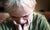 Depressed crying woman sitting with her head down