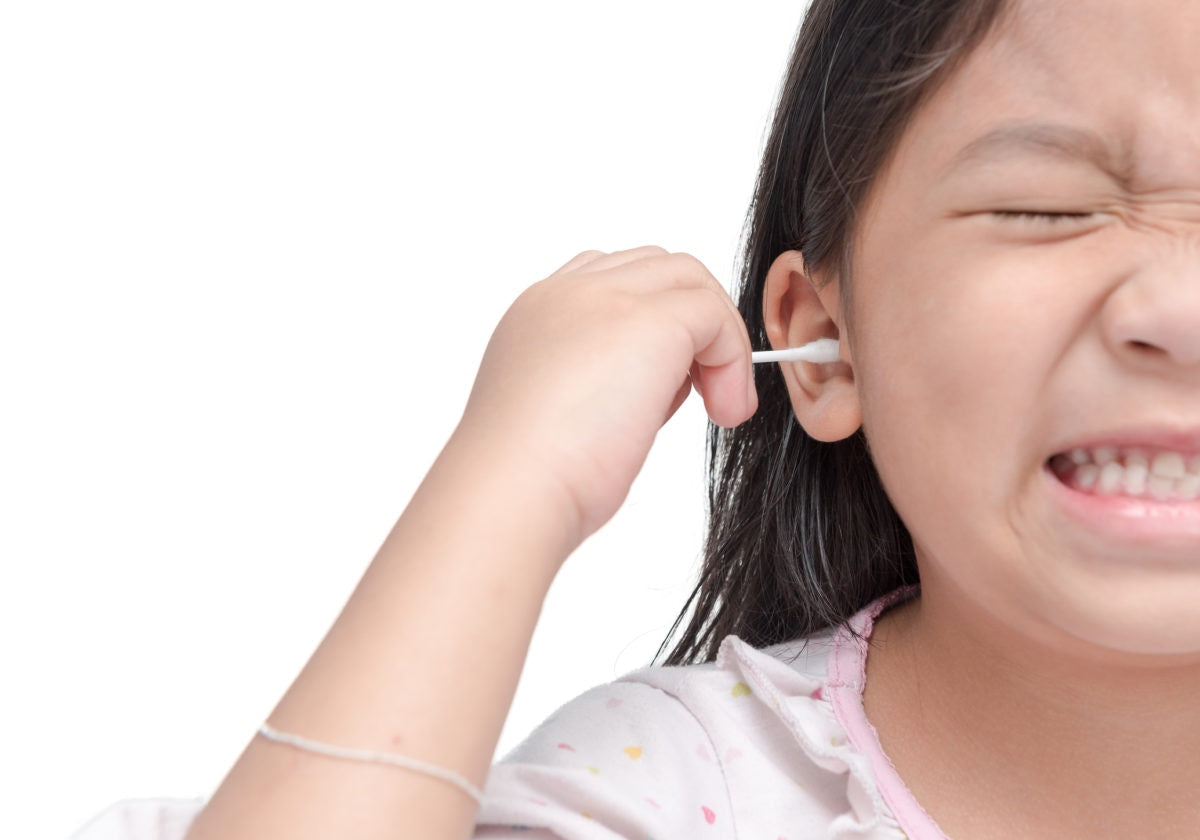 young girl using cotton swabs 