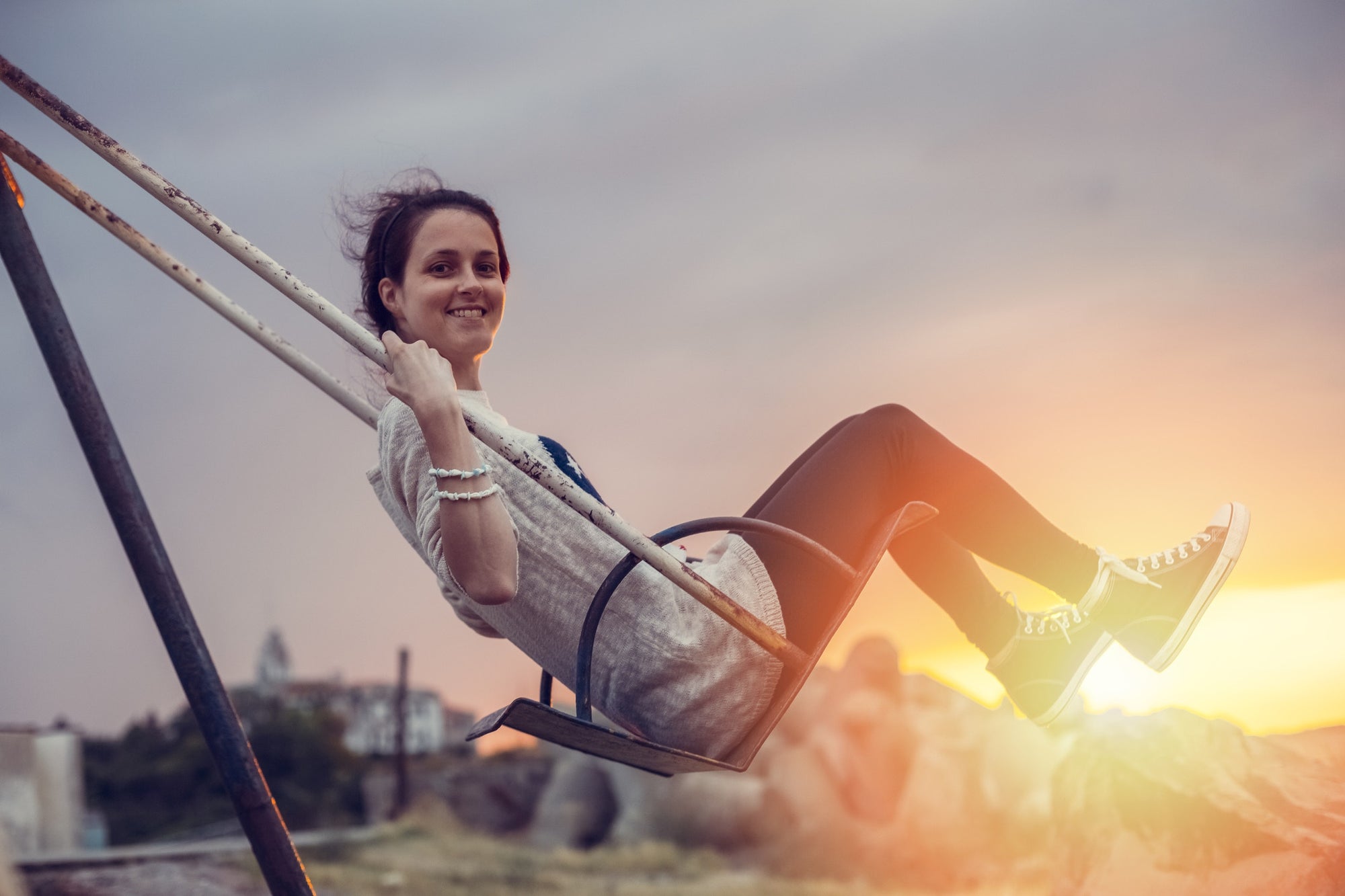 pretty girl swinging on a swing in a park