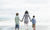 Mom And Her two sons Walk Hand In Hand At The Beach