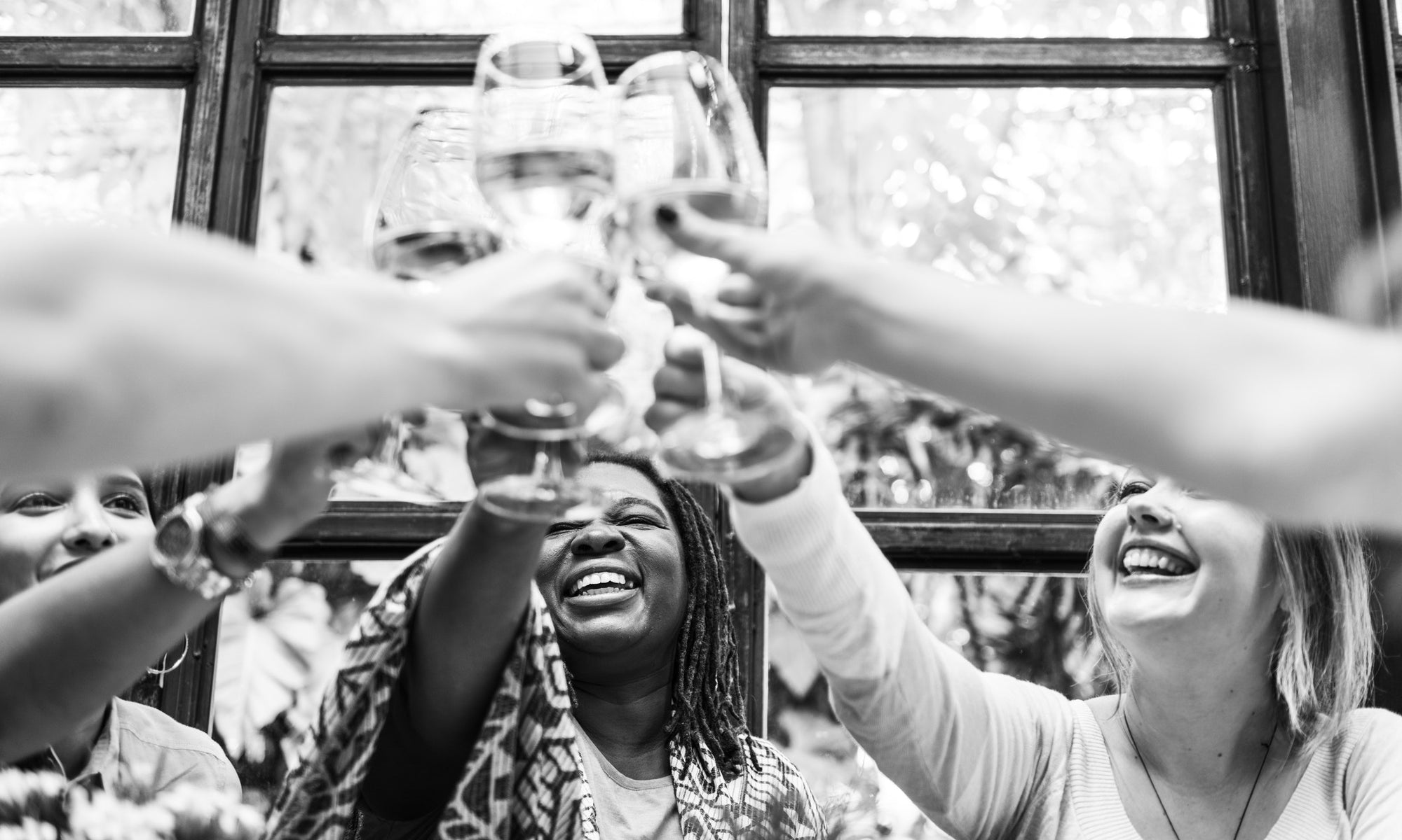 Happy women Cheering With Wine Glasses