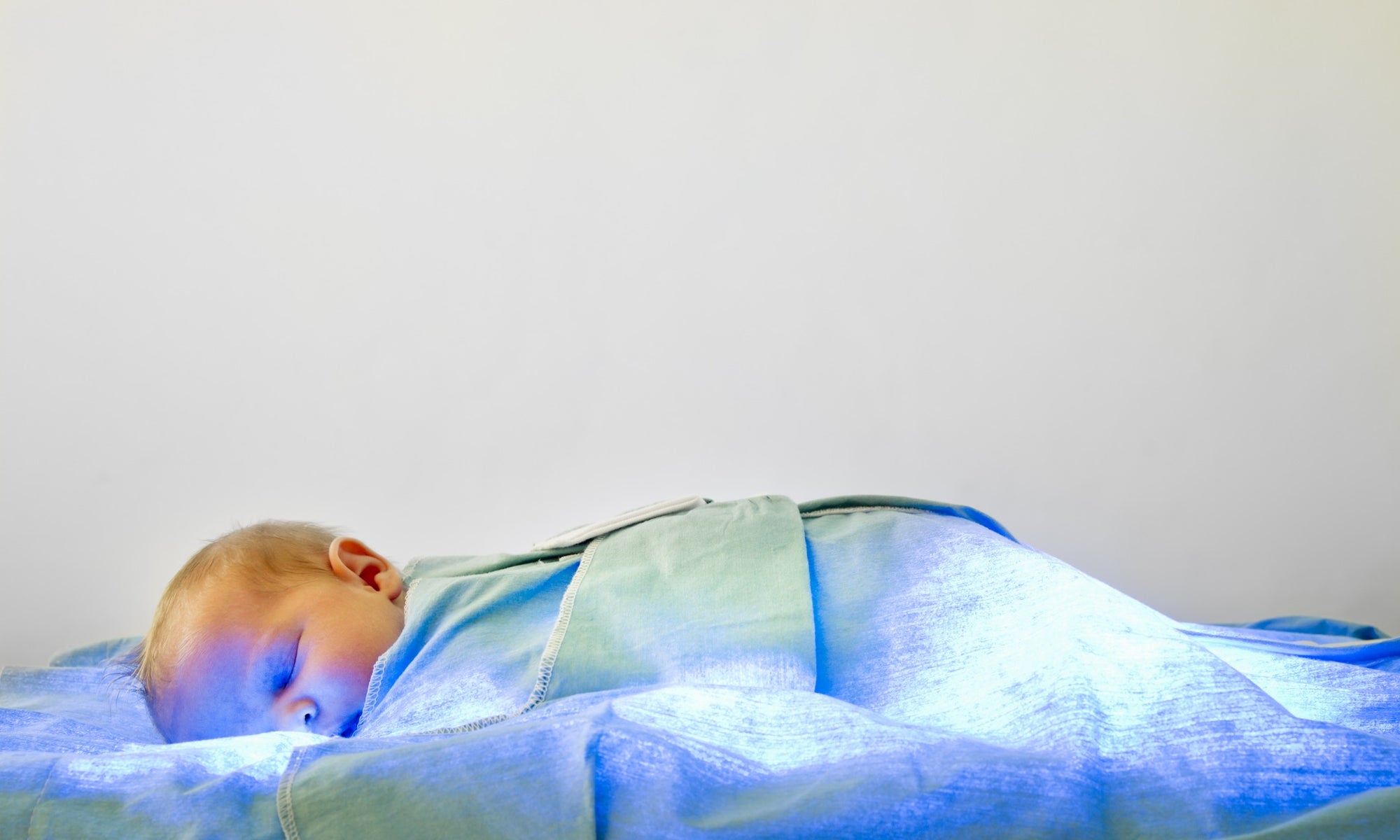 Baby sleeping on blue blanket