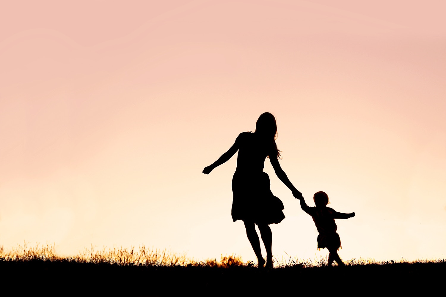 Mother and Baby Daughter Running and Dancing at Sunset