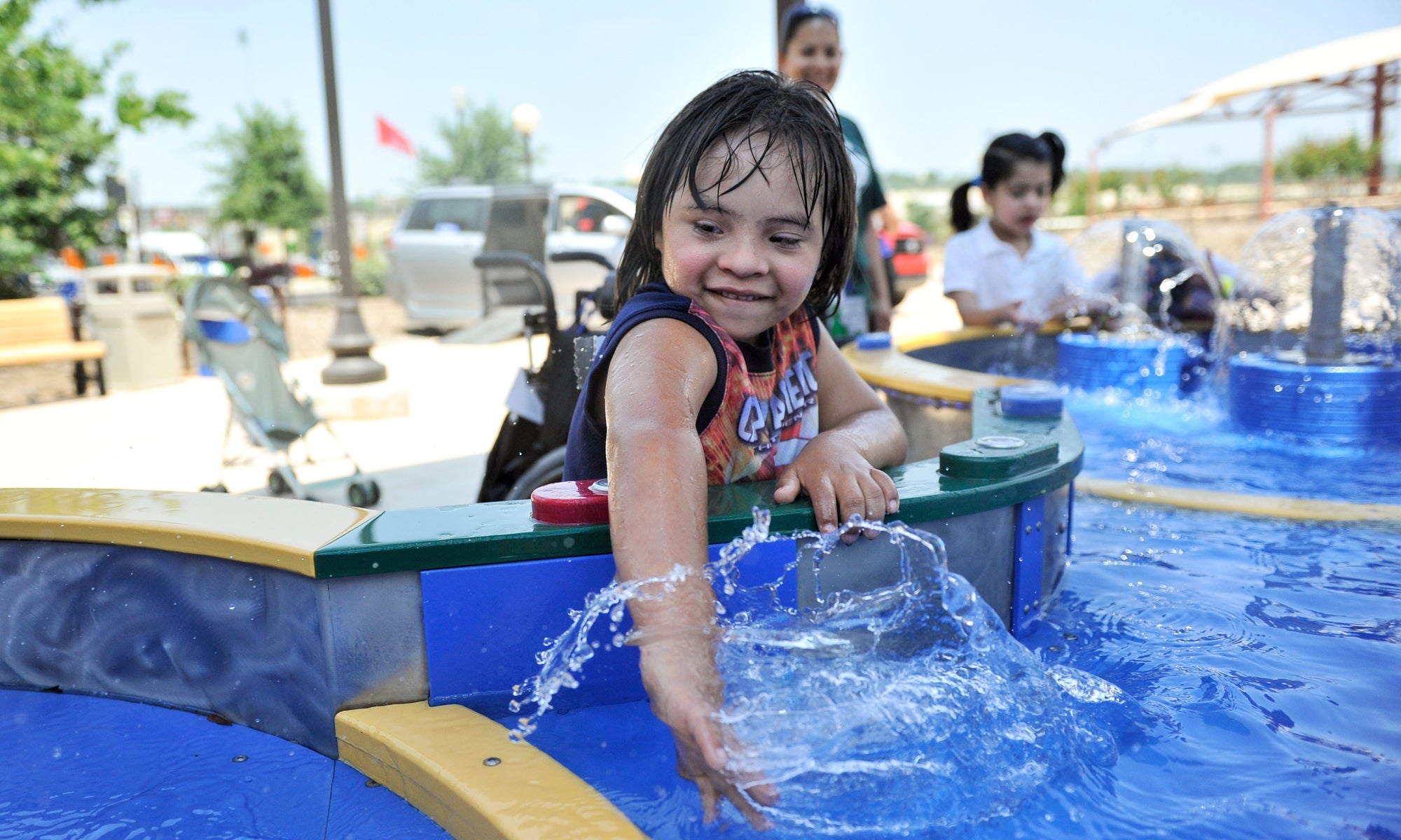 Child on a water park , splashing water fro pool