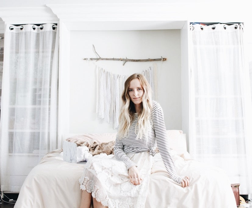 A girl dressed on white on a white room