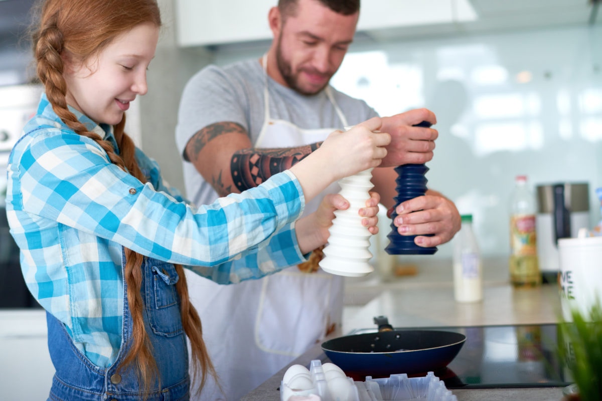 Two guys are cooking in a kitchen