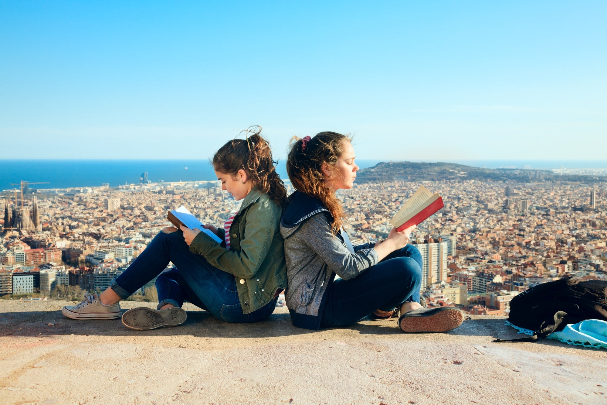 Two girls are reading books