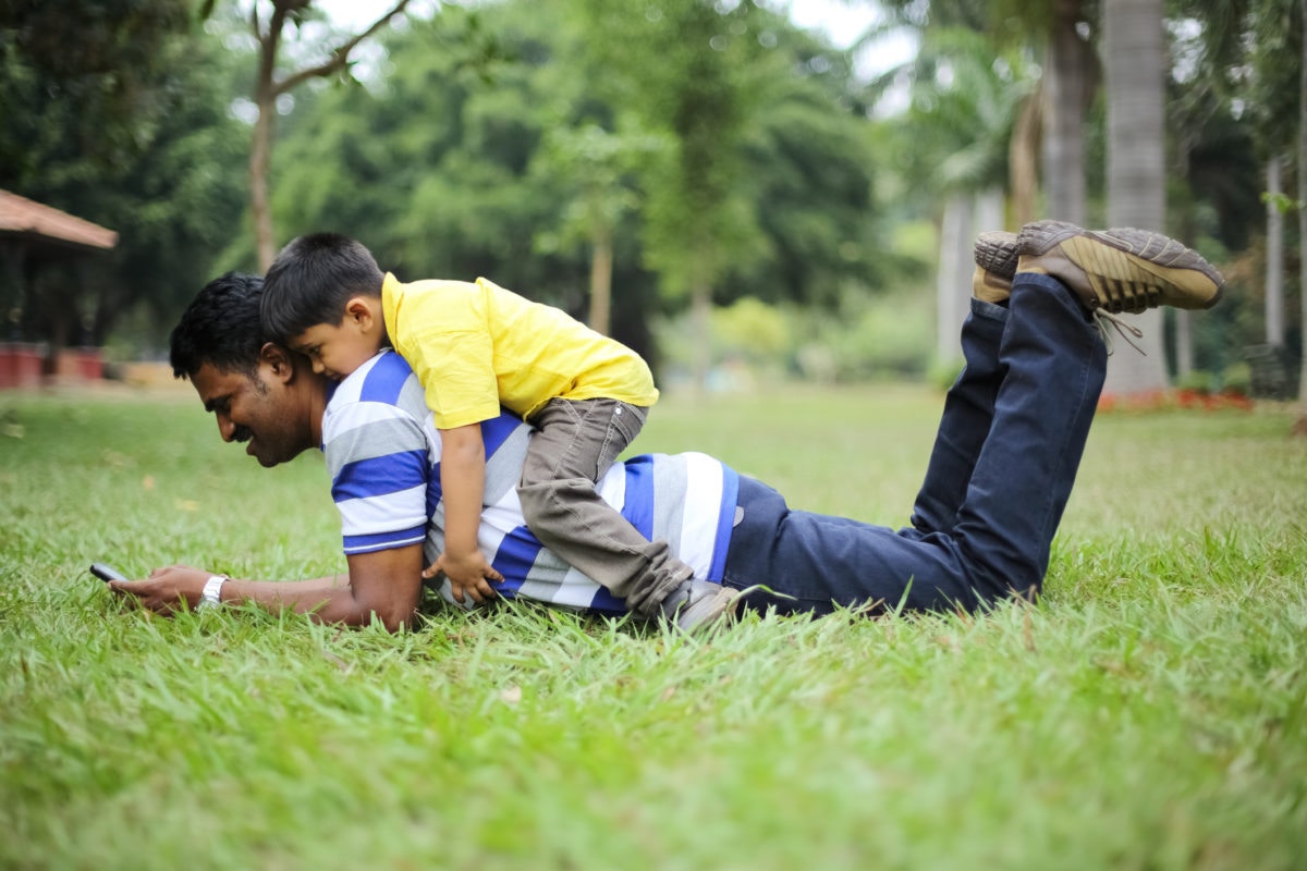 happy dad and his child playing outdoors