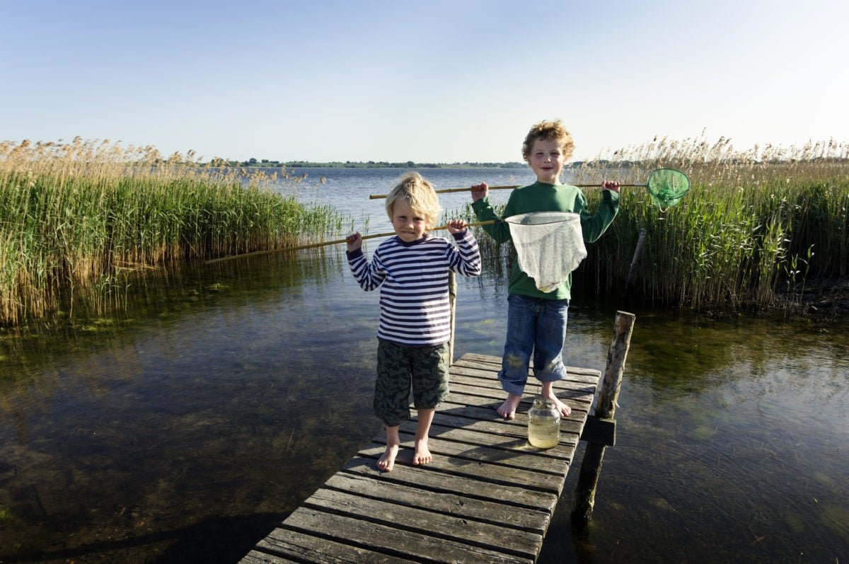 young boys with fish net in their hand.
