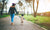 A mother and kid is walking on park by holding hand