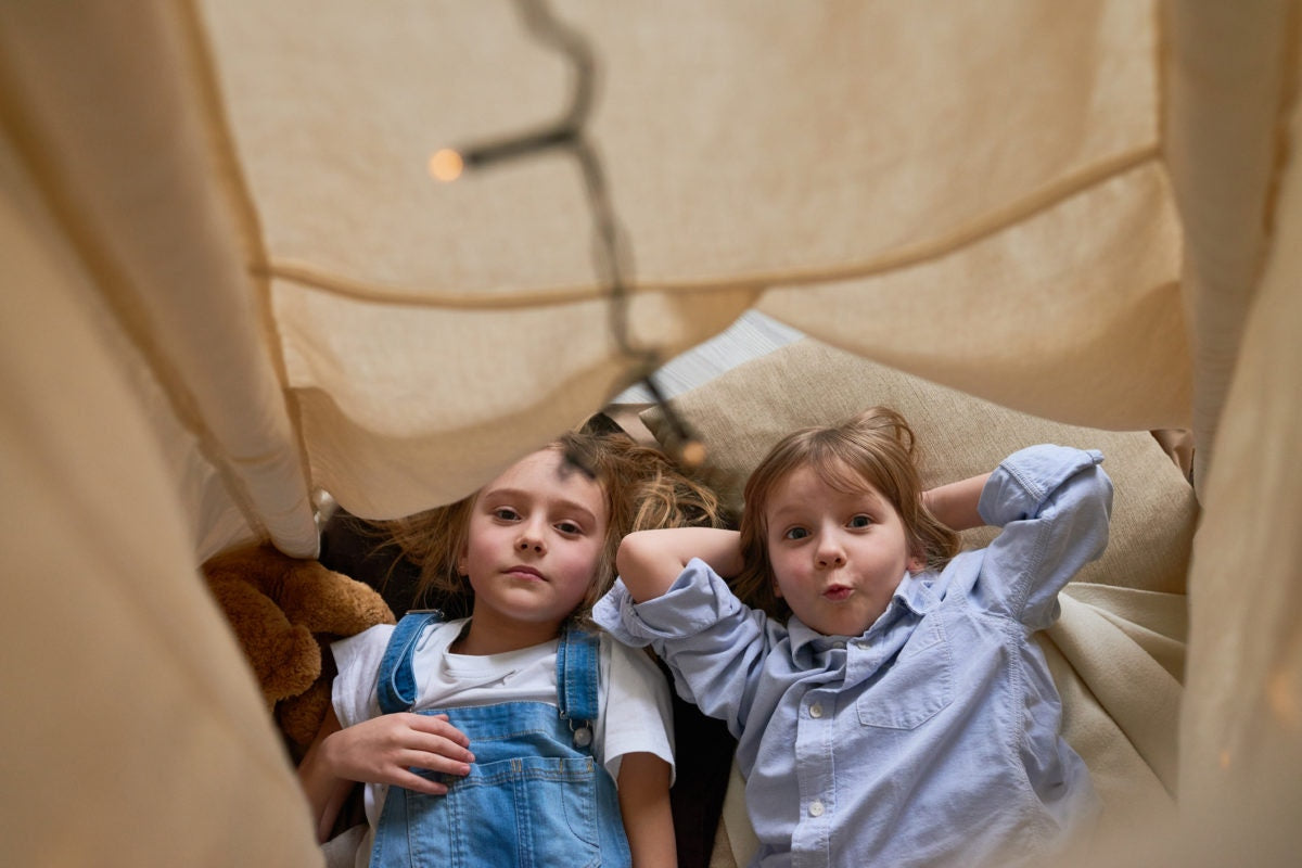 boy and girl lying together in bed looking up