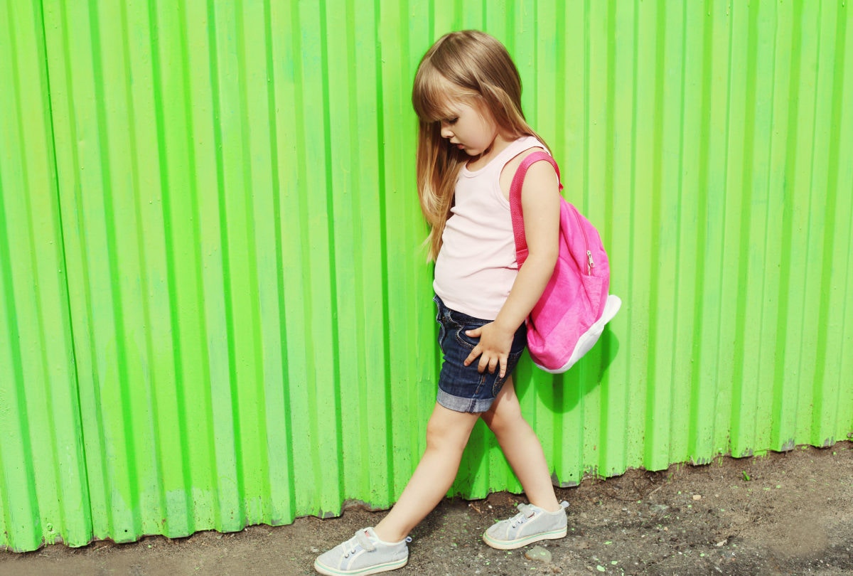 sad young girl with pick backpack