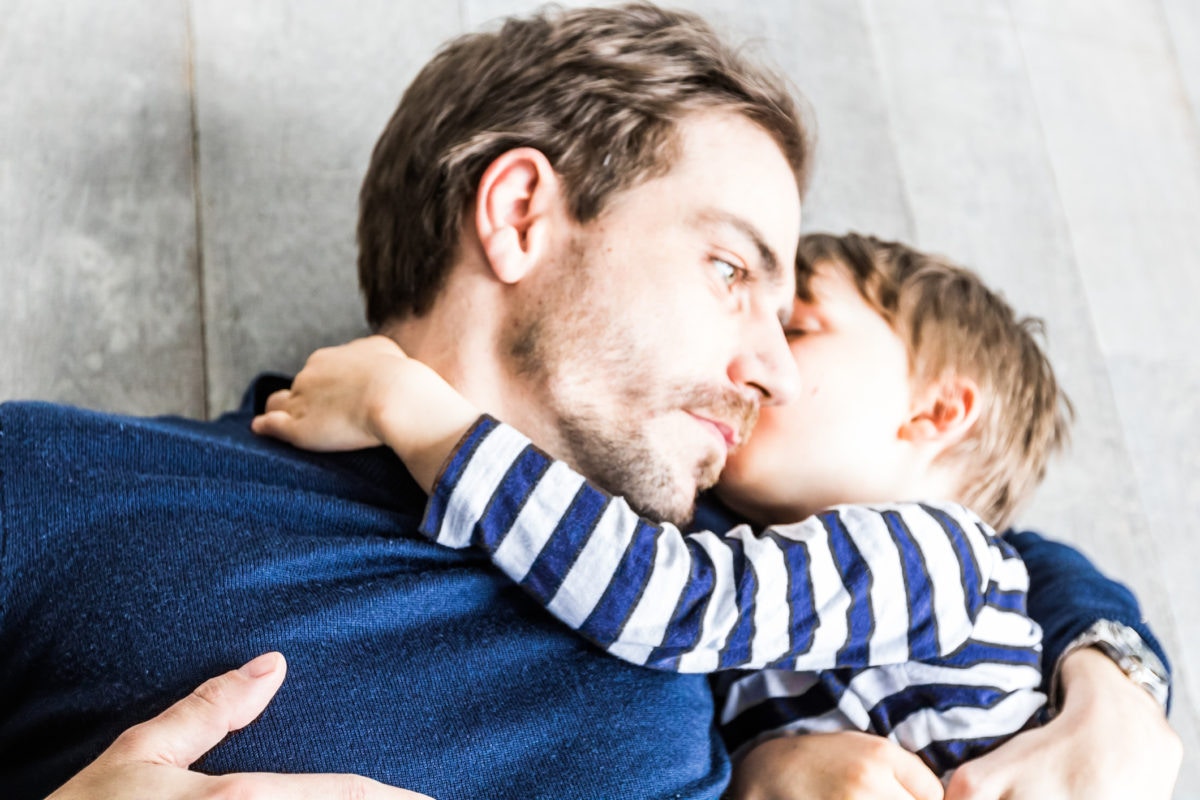 Little boy kissing his father