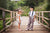 Two children standing on a bridge