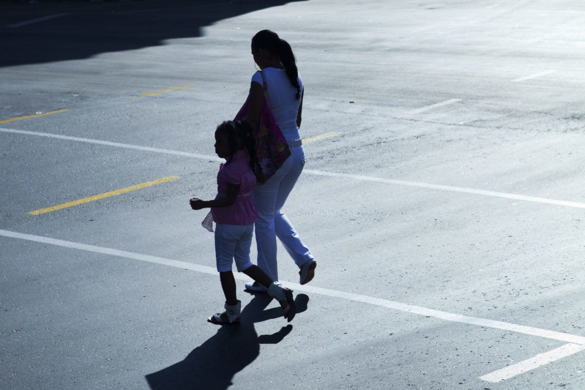 Mother and her kid crossing a street