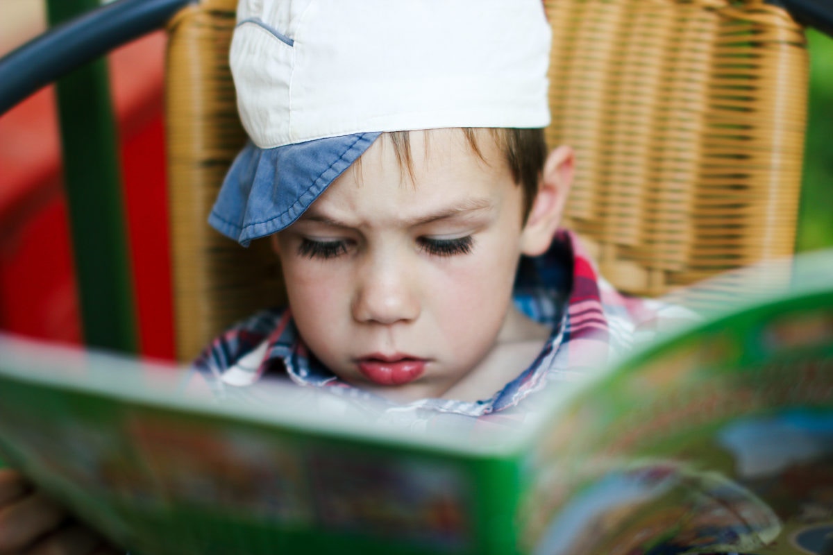 Little Boy Reading Comic Book