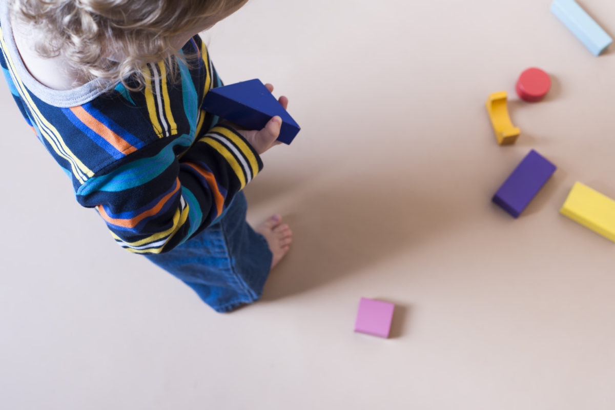 A baby playing with blocks