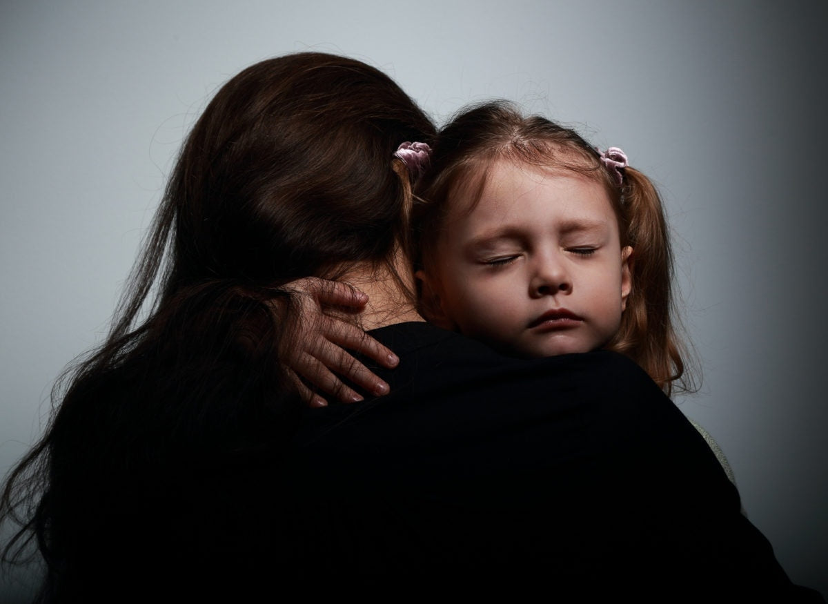 Close up face of little baby girl gives big hug to her mother and closing eyes for pleasure