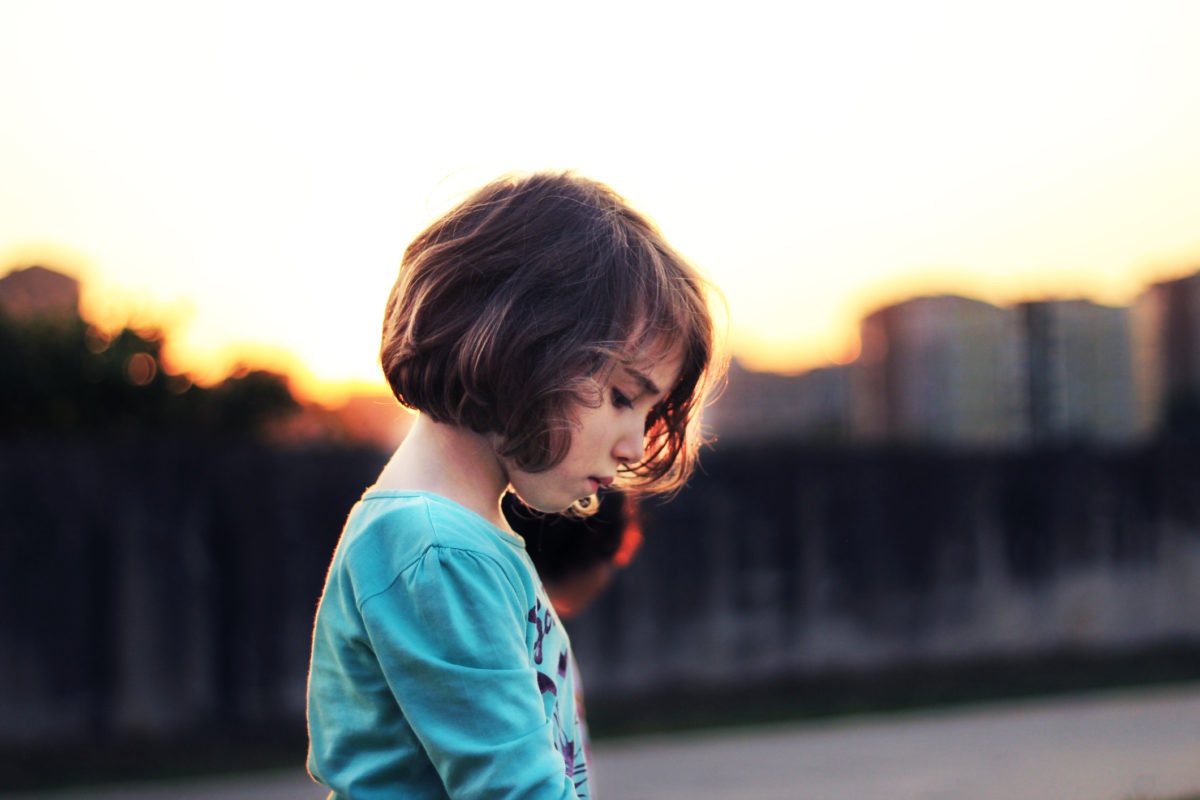 little girl with short hair heads down