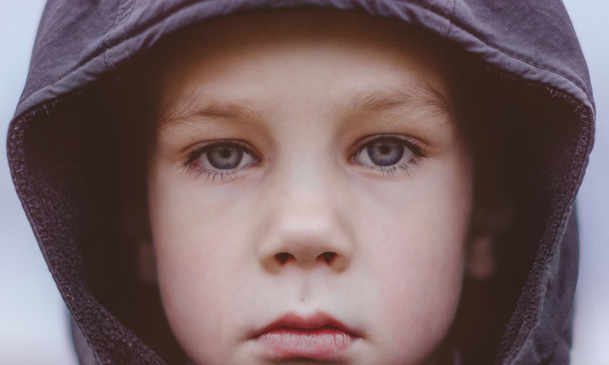 boy with grey eyes looking at camera