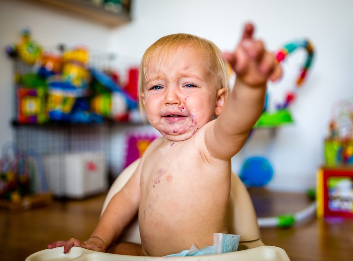 baby pointing with food on it