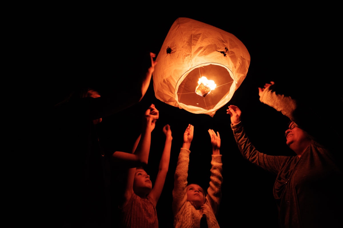 family putting a paper bag with fire it it bag floats away