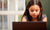 young girl looking at computer screen