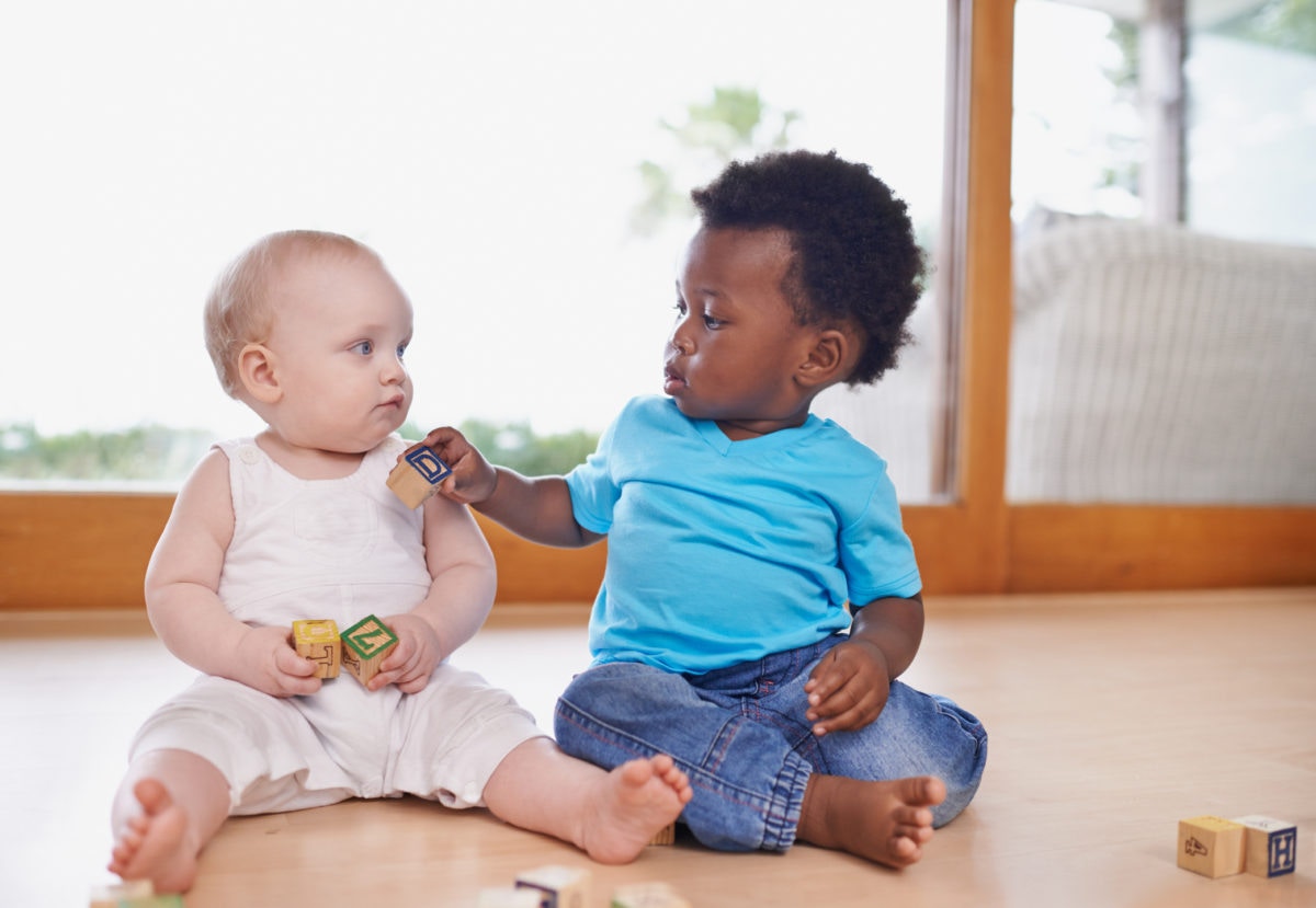 Little children playing with building blocks