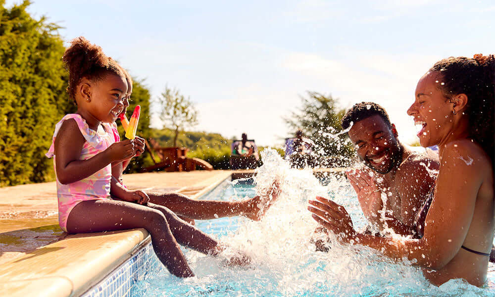 family playing in pool