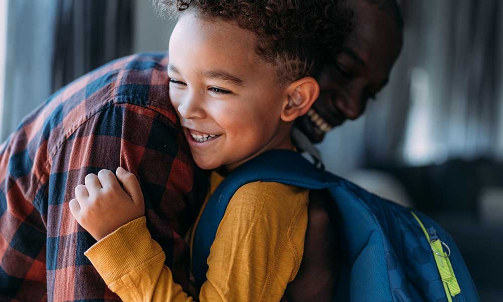 un niño con su padre el primer día de colegio