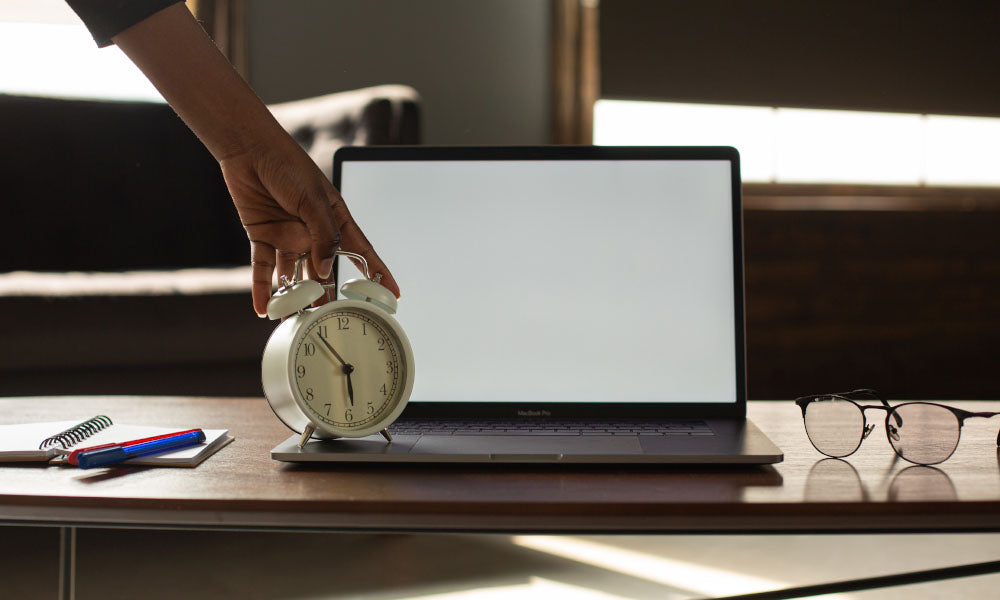 clock on top of laptop keyboard.