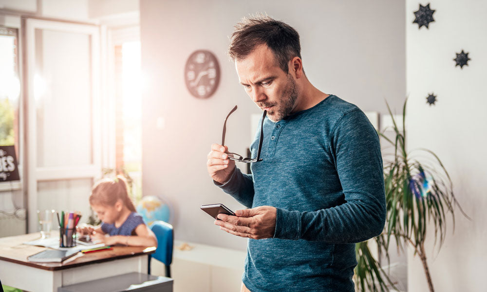 father looking at his phone