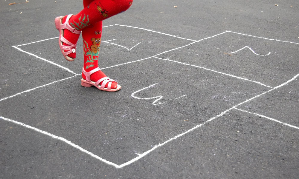 Girl with red socks and pink sandals playing